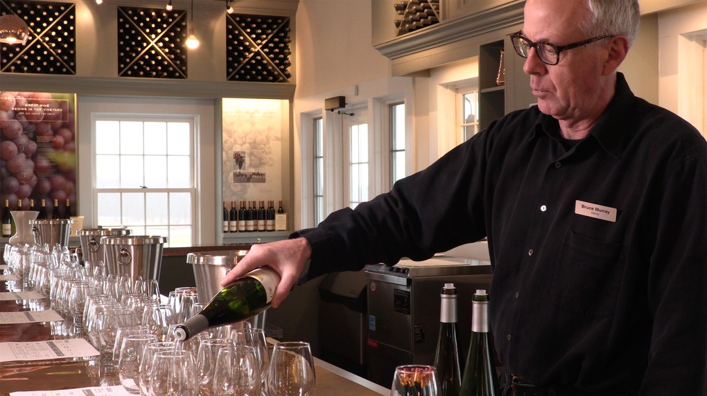 Owner Bruce Murray pouring wine for guests.